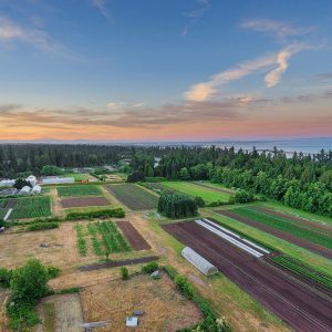Aerial shot of UBC Farm showing the sky, land and water