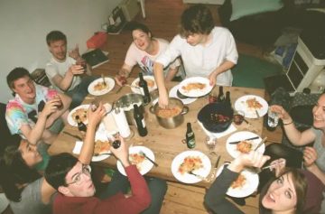 A group of friends sitting around a table of food